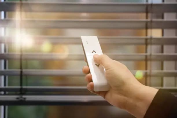 Motorized window shades covering a wall of windows in a living room