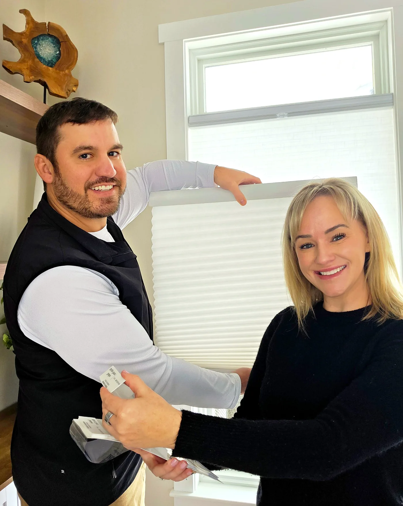 Matt and Ashleigh holding a cellular shade sample
